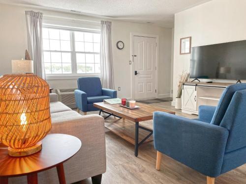 a living room with a couch and chairs and a table at Gateway to Greenwich Suites in Saint Peters