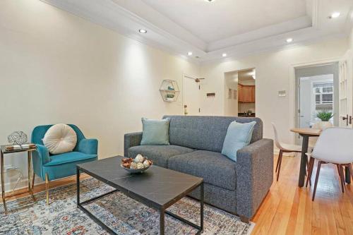 a living room with a couch and a table at 2BR Alluring Apartment with Laundry - Cullom D3 in Chicago