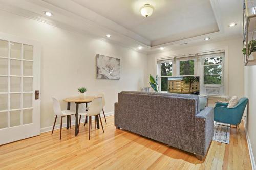 a living room with a couch and a table at 2BR Alluring Apartment with Laundry - Cullom D3 in Chicago