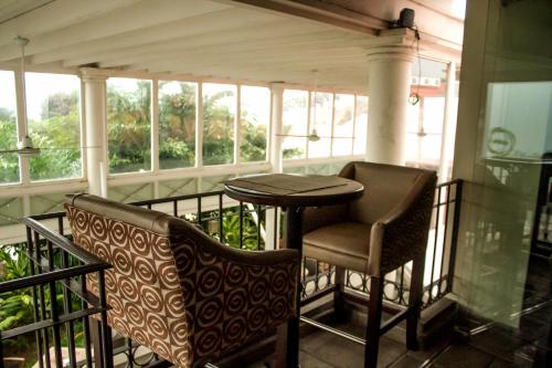 a porch with two chairs and a table on a balcony at La Riviera Hotel in San Antonio