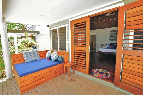 a porch with a bench on a deck at Blue Lagoon Beach Resort in Nacula Island