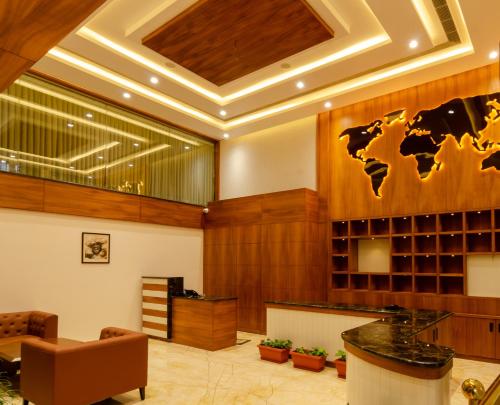 a lobby with a world map on the wall at Chithara Comforts in Udupi