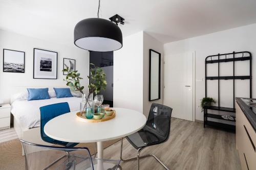 a living room with a white table and chairs at New Central Studio with Parking in Ljubljana