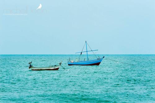 two boats sitting in the water in the ocean at Amotape Comfort in Zorritos