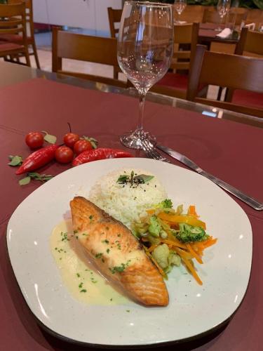 a plate of food with a fish and vegetables on a table at Boulevard Park Hotel in São Luís