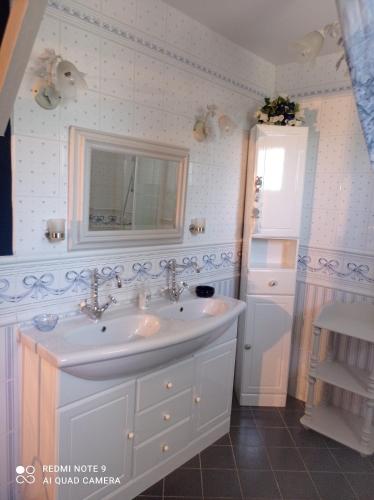 a bathroom with a sink and a mirror at La Gravière 