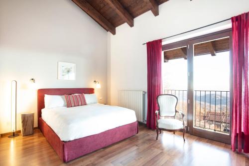 a bedroom with a bed and a large window at Cascina il Faggio Country House in Mosso Santa Maria