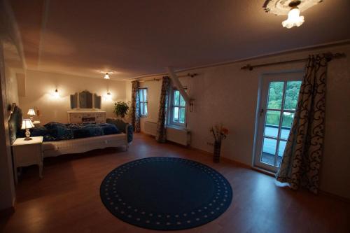 a living room with a bed and a blue rug at Moseljuwel mit exklusiver Sauna und Indoor Pool in Traben-Trarbach