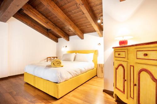 a bedroom with a large bed and a wooden ceiling at Cascina il Faggio Country House in Mosso Santa Maria