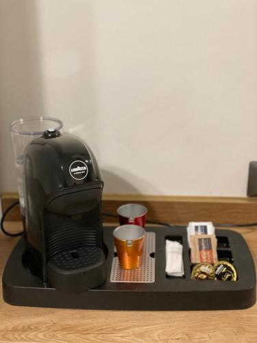 a coffee maker with a cup on a tray at Casa Vacanze SANGALLO in Nettuno