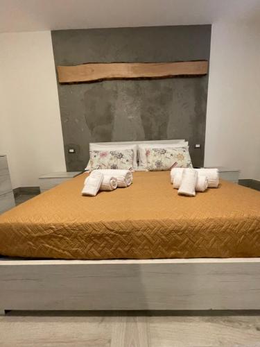 a bed with two rolled up towels on it at Casa Vacanze SANGALLO in Nettuno