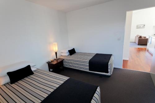 a hotel room with two beds and a living room at Ski Time in Methven