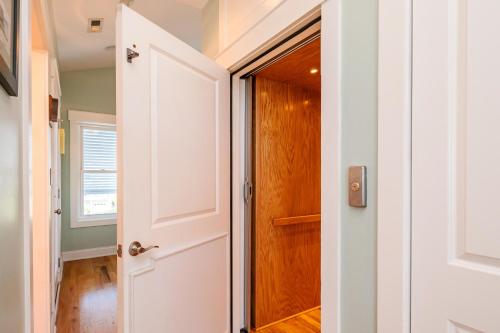 a door leading into a bathroom with a closet at Turtle Watch Too by Oak Island Accommodations in Caswell Beach