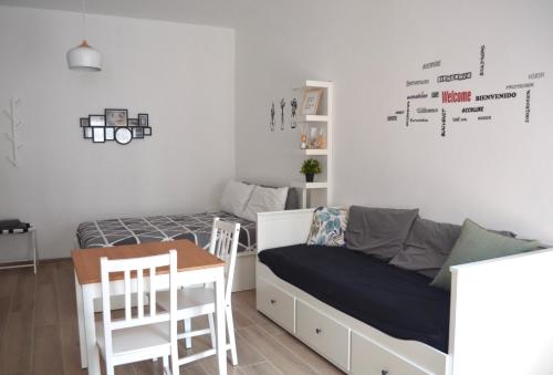 a bedroom with a bed and a desk and a table at Bed&Coffee Milano in Milan
