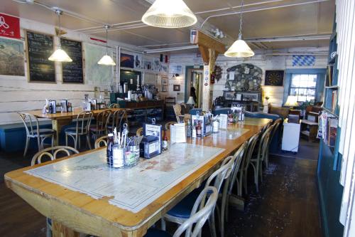 a restaurant with tables and chairs in a room at Talkeetna Roadhouse in Talkeetna