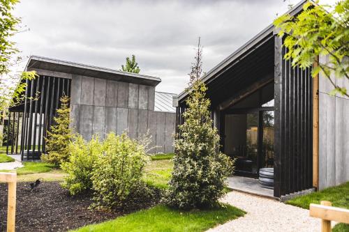 a modern house with a black facade at Newton Hall in Chathill