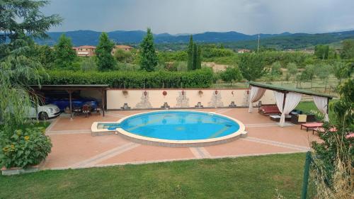 a large swimming pool in a yard with a house at Il Paradiso Segreto in Pistoia