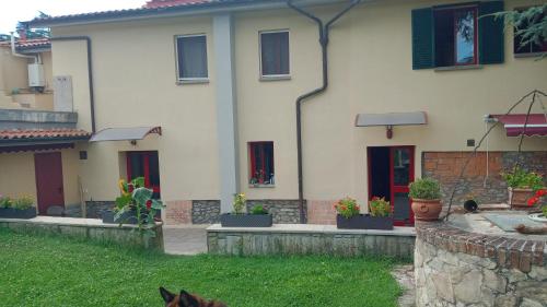 a house with a dog sitting in front of it at Il Paradiso Segreto in Pistoia