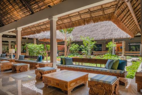 a resort lobby with couches and tables at Iberostar Waves Tucan - All Inclusive in Playa del Carmen