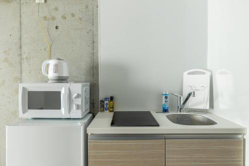 a white microwave sitting on top of a refrigerator at Marvelous Koiwa - Vacation STAY 90819v in Tokyo