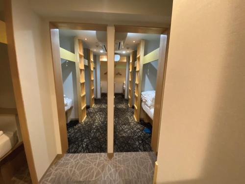 a hallway of a dorm room with bunk beds at commun ryogoku - Vacation STAY 96357v in Tokyo