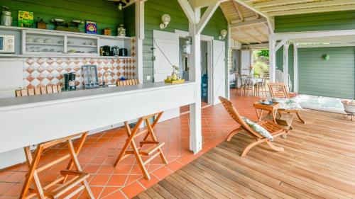 a patio with chairs and a bar on a house at Beausejour Guest House in Pointe-Noire