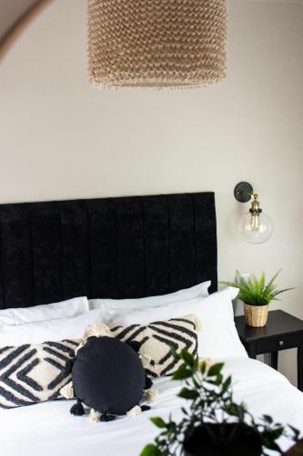 a black and white bed with a black headboard at Plymouth Barbican boutique luxury Apartment in Plymouth
