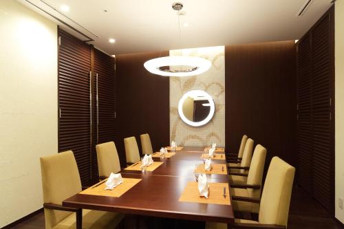 a dining room with a long table and chairs at Tokyo Green Palace in Tokyo