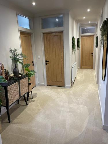 a hallway with a door and a table with plants at Plymouth Barbican boutique luxury Apartment in Plymouth