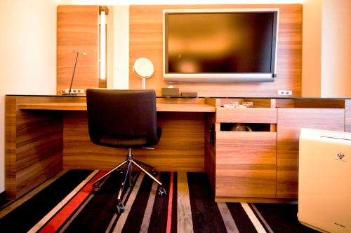 a desk with a chair and a television on it at Tokyo Green Palace in Tokyo