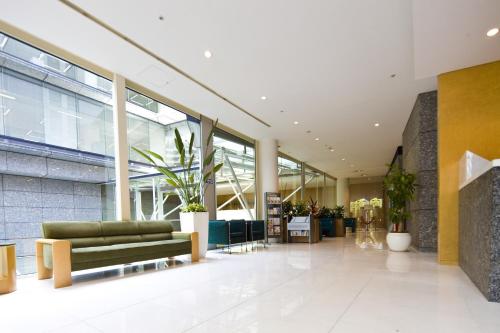a lobby with a green couch in a building at Tokyo Green Palace in Tokyo