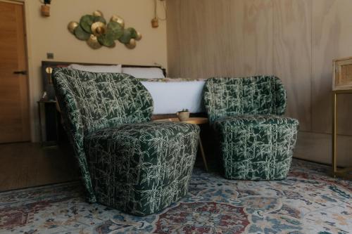 two chairs sitting next to each other on a rug at Newton Hall in Chathill