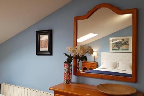 a bedroom with a large mirror on the wall at Ático muy luminoso con Parking, in Zaragoza