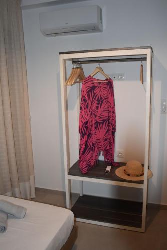 a display case with a shirt and a hat at Pervoli in Faliraki