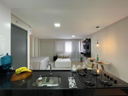 a kitchen with a sink and a room with a bed at Mardisa Design by Jess Hospedagens in João Pessoa