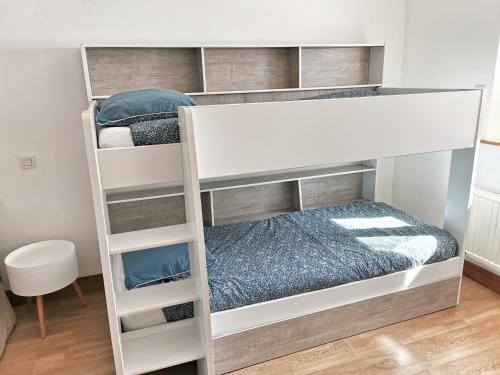 a white bunk bed in a room at Gîte Le Petit Bacchus in Sainte-Croix-Hague