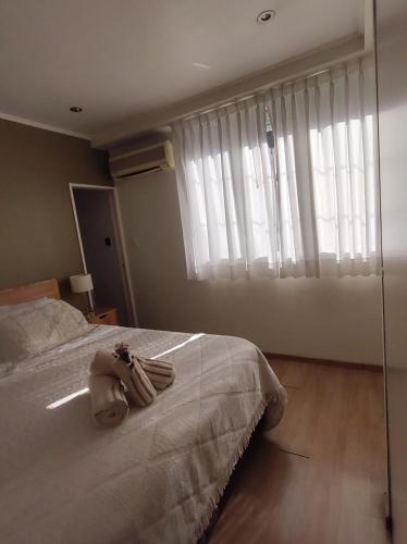 a bedroom with a bed and a large window at My Place Buenos Aires in Buenos Aires