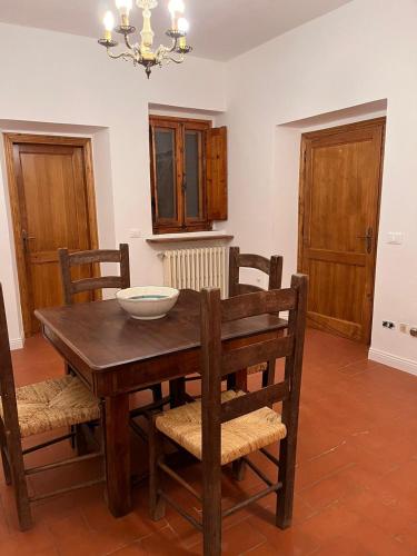 a dining room with a wooden table and chairs at Casa Solatii Montefioralle in Greve in Chianti