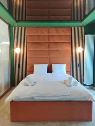 a bedroom with a large bed with white sheets and pillows at Piotrkowska.eu Apartament Romantica in Łódź