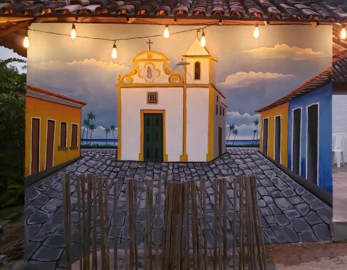 a painting of a church on a wall at Céu Azul Pousada in Arraial d'Ajuda