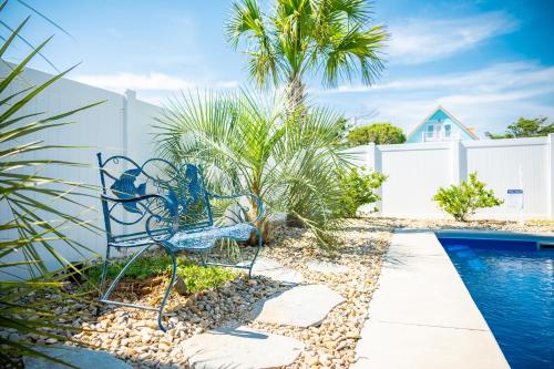 a blue bench sitting next to a swimming pool at The Anchor Holds by Oak Island Accommodations in Oak Island
