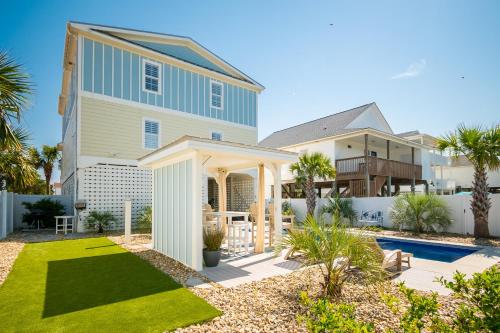 a house with a yard with a swimming pool at The Anchor Holds by Oak Island Accommodations in Oak Island