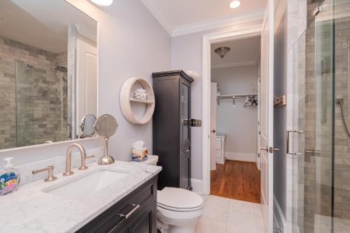 a bathroom with a toilet and a sink and a shower at The Anchor Holds by Oak Island Accommodations in Oak Island