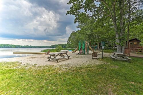 a park with benches and a playground next to a lake at Near Skiing and Hiking Gouldsboro Home with Hot Tub in Gouldsboro