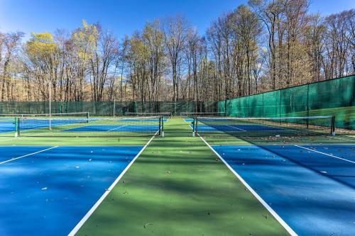 two tennis courts with trees in the background at Near Skiing and Hiking Gouldsboro Home with Hot Tub in Gouldsboro