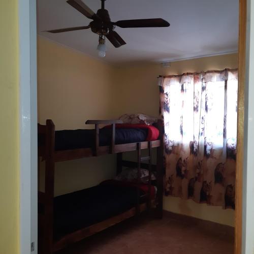 a room with two bunk beds and a ceiling fan at ALVY in Victoria