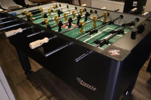 a foosball table with a green at Private house Kuranoya Sapporo in Sapporo