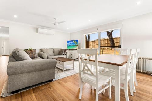 a living room with a table and a couch at Bronzewing Haven in Cowes