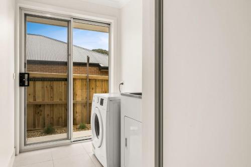 a washing machine in a room with a window at Bronzewing Haven in Cowes