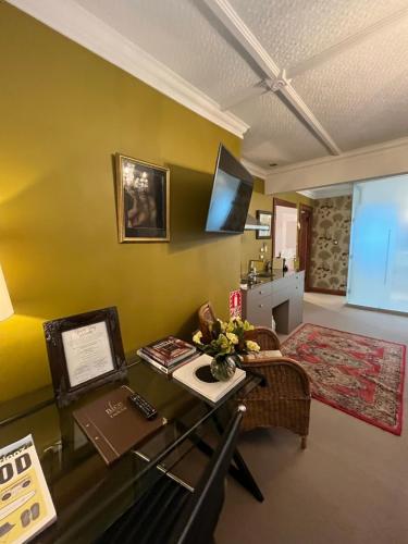 a living room with a desk and a television at Nice Hotel in New Plymouth